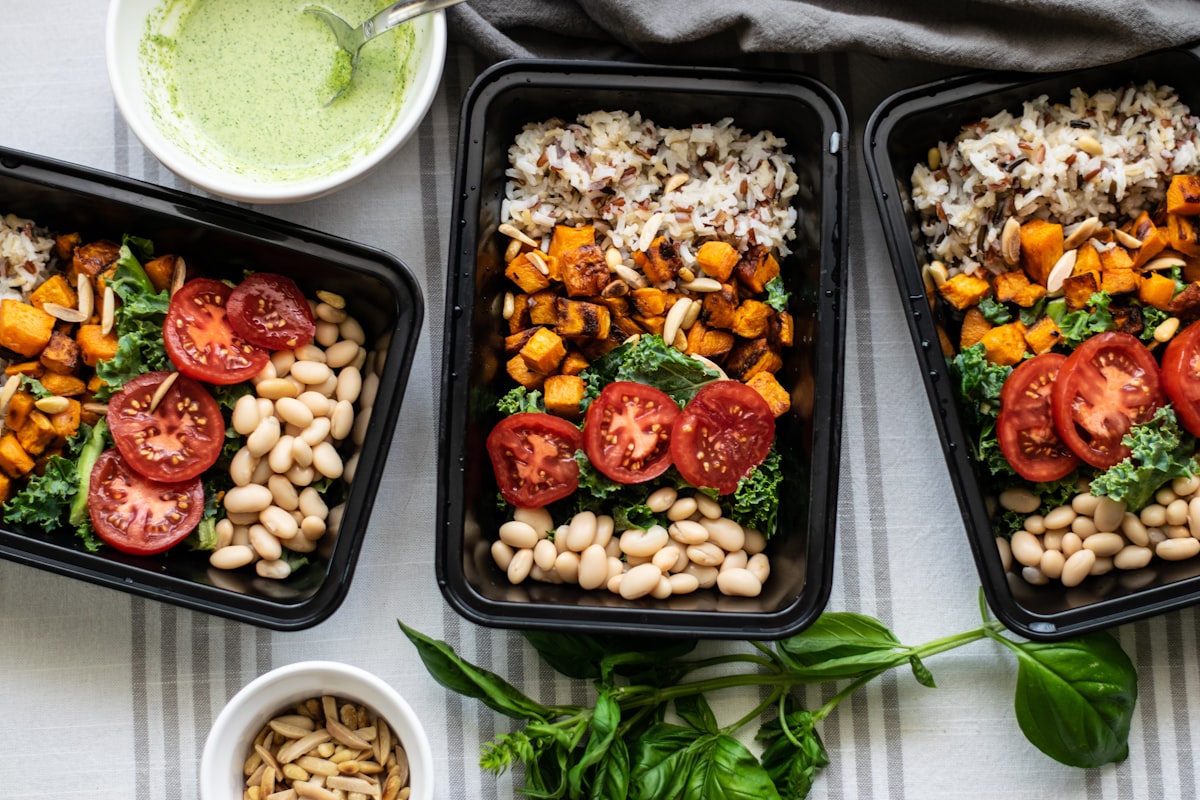Multiple portioned meals arranged in glass containers on shelf
